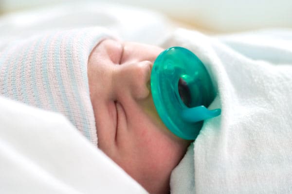 sleeping newborn with pacifier