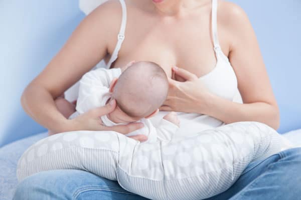 using a breastfeeding pillow is helpful for nursing a newborn baby