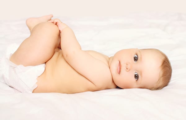 baby on bed with diaper